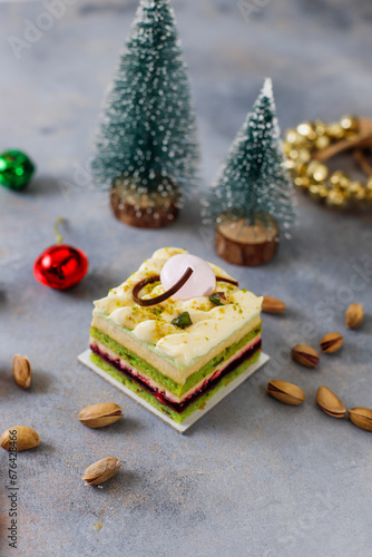 Pistachio cake slice with christmas decoration background.