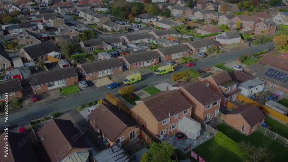 Drone 50fps. Filmed form above. Ambulance attending a patients house in a suburban setting. Filmed Yorkshire UK Drone 50fps. Filmed form above. Ambulance attending a patients house in a suburban setting. Filmed Yorkshire UK