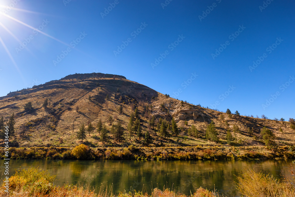 Deshutes River at the base of rimrock cliffs in Eastern, Oregon, USA Deshutes River at the base of rimrock cliffs in Eastern, Oregon, USA