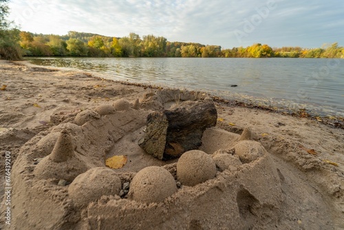 Sand castlle built on a sandy lakeshore photo