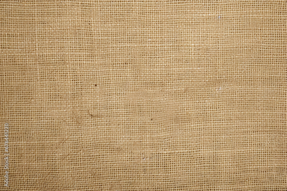 Rough burlap textile texture in natural tan color Rough burlap textile texture in natural tan color
