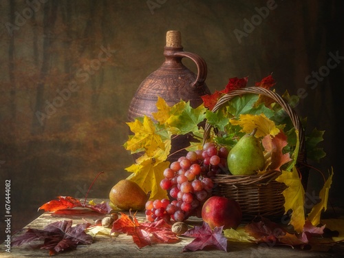 Autumn still life with fruits and falling leaves photo