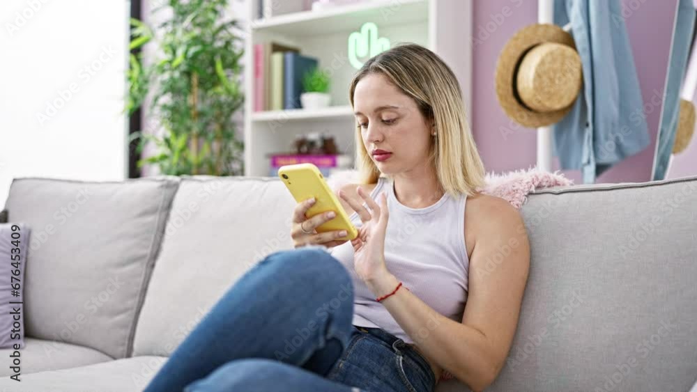 Young blonde woman sitting on the sofa stressed for fail selfie at street Young blonde woman sitting on the sofa stressed for fail selfie at street