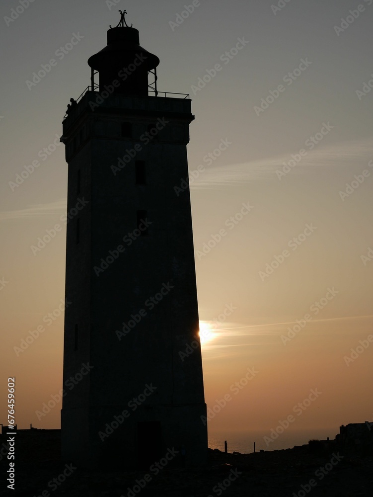 Vertical shot of a beautiful lighthouse during the sunset