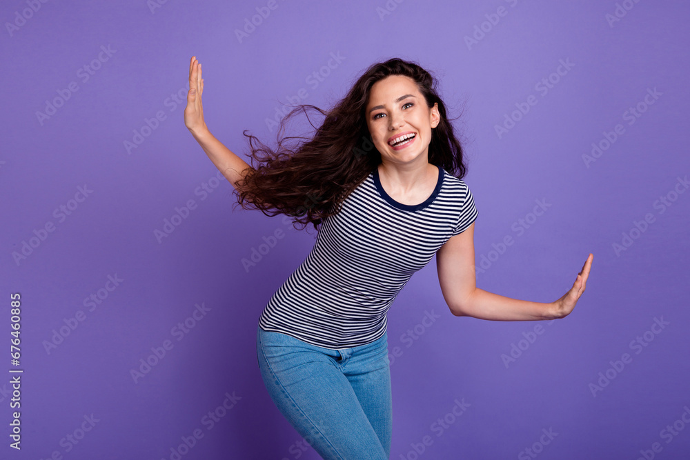 Naklejka premium Photo of young carefree latin chic dancing alone when hearing her favorite hispanic soundtrack isolated on purple color background