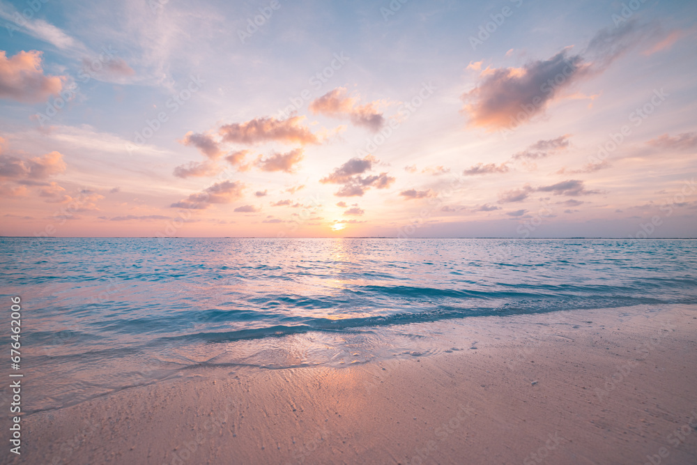Beautiful sunset horizon sea or ocean. Vibrant soft colors magic sunlight. Small clouds yellow golden sky, reflection of sun water sand on beach. Peaceful romantic vacation in tropical island paradise - obrazy, fototapety, plakaty 