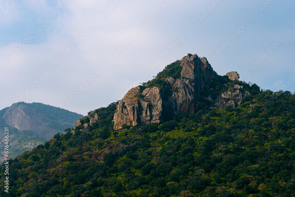 Scenic view of the mountains and the cloudy sky Scenic view of the mountains and the cloudy sky