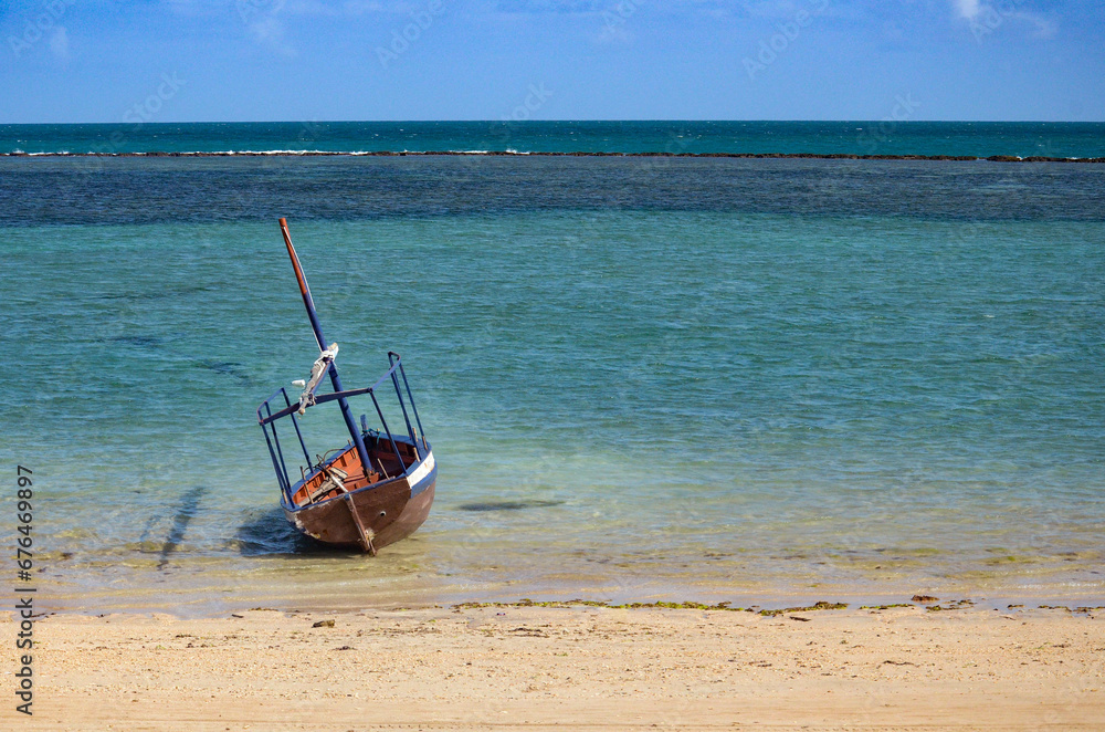 Boat lying in the sand during low tide Boat lying in the sand during low tide