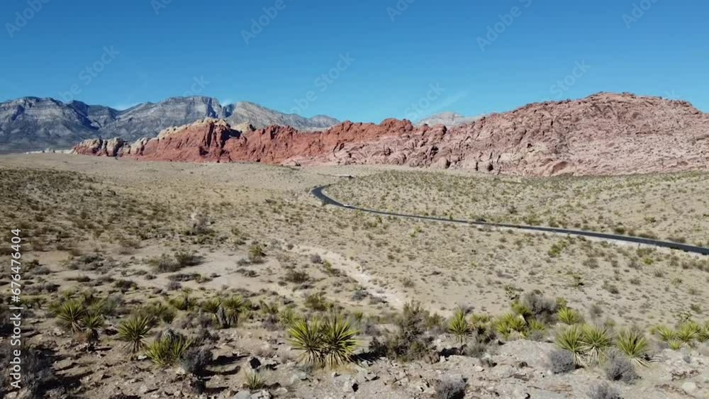 Drone flight over Red Rocks Canyon near Las Vegas, following a road through the stunning desert. Drone flight over Red Rocks Canyon near Las Vegas, following a road through the stunning desert.