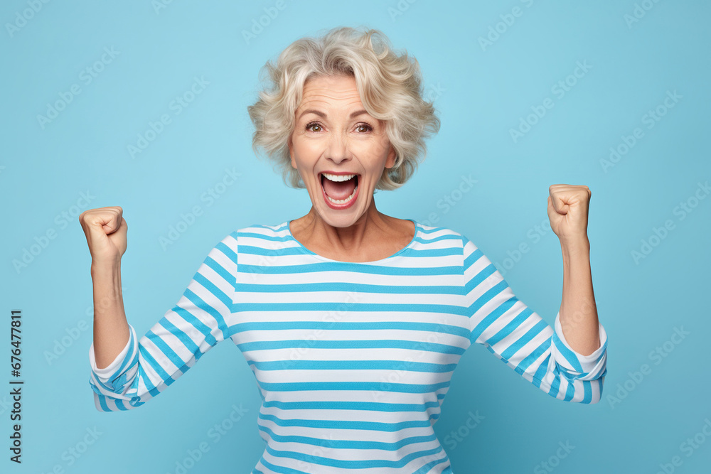 Elderly exultant overjoyed jubilant woman 50s years old wear light striped shirt look camera spread hands say wow isolated on plain pastel blue cyan color background studio portrait Lifestyle concept Elderly exultant overjoyed jubilant woman 50s years old wear light striped shirt look camera spread hands say wow isolated on plain pastel blue cyan color background studio portrait Lifestyle concept