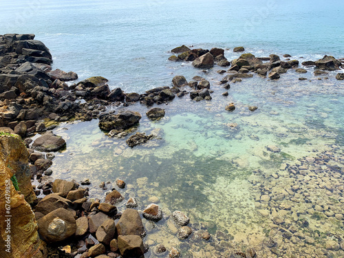 View of the ocean with a beautiful rocky beach, with stones and rocks. Indian Ocean, Sri Lanka, Merissa