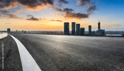 asphalt road and city skyline with modern building at sunset in suzhou jiangsu province china photo