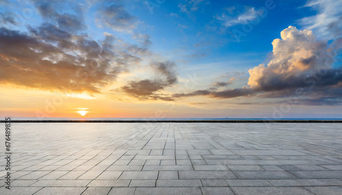 empty square floor and coastline with sky clouds at sunrise