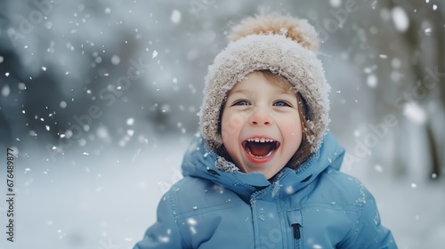 A young boy in a blue jacket and hat enjoying the snowy weather