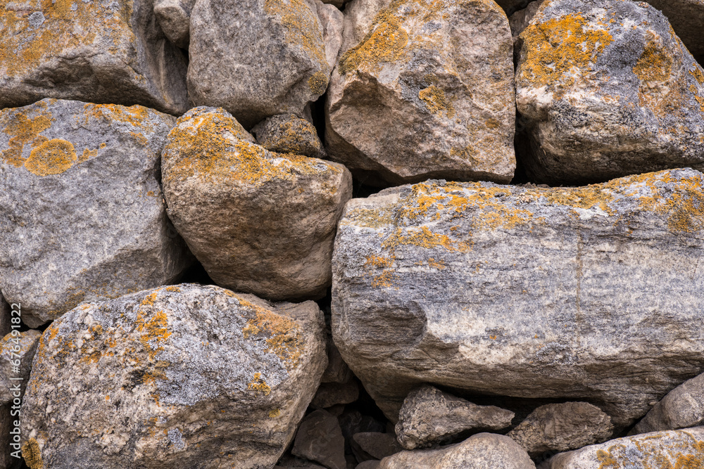 The walls are made of large stones and cobblestones. Stone background.