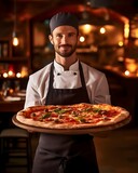 A chef holding a delicious pizza.
