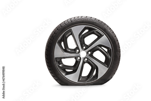 Studio shot of a flat vehicle tire with a rim photo