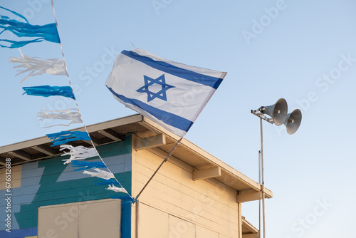 Israeli flag with the Star of David symbol proudly adorns a lifeguard booth on the  beach of Israel. photo