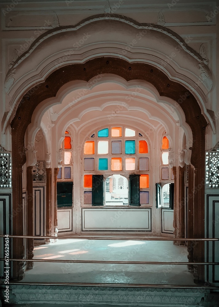 Vertical shot of colorful windows of inner part of the Hawa Mahal Palace in Jaipur, Rajasthan, India