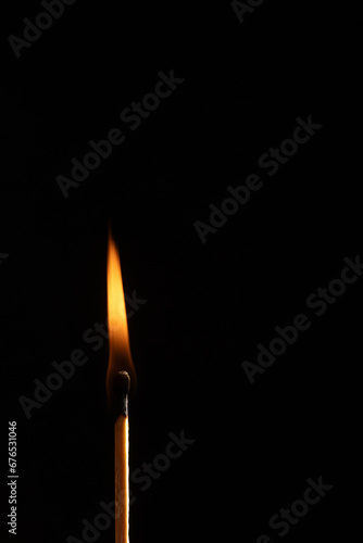 a wooden safety matchstick burning 
