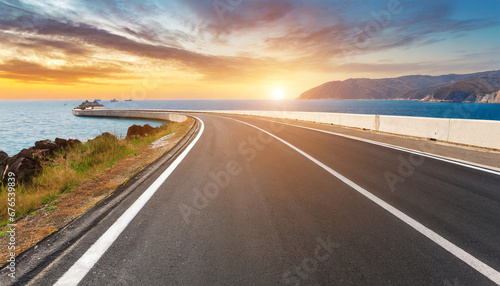 asphalt highway road at sunset by the sea