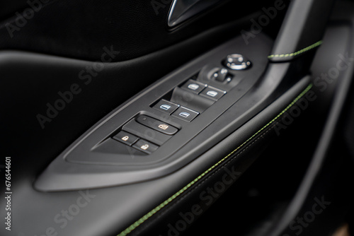 car window button panel on left doors with leather and plastic material