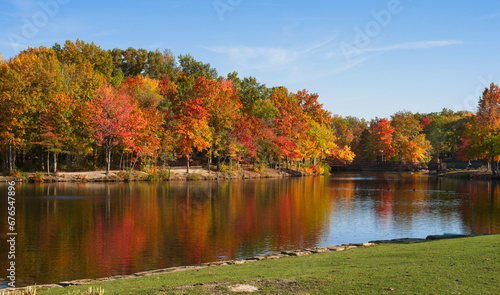 Brilliant autumn colors reflected in Coe Lake in Berea, Ohio photo