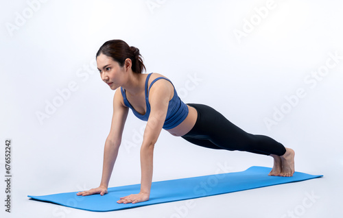 Energetic and determination asian woman push up on exercising mat for effective chest targeting muscle gain. Pursuit of fit physique and commitment to healthy lifestyle. Isolated background. Vigorous