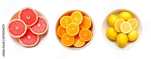 Top view of citrus fruit, grapefruit, orange and lemon slices in bowls over white transparent background