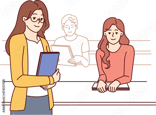 Woman rector and students seated in university auditorium to advertise education programs and grants