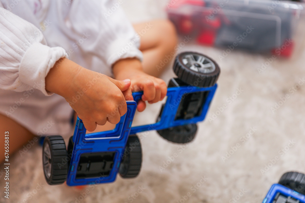 Children's colorful toys, tiny legs, and building blocks scattered on the floor, a playful scene of early childhood development Children's colorful toys, tiny legs, and building blocks scattered on the floor, a playful scene of early childhood development