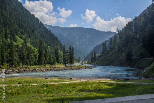 Picture of Mountain, Trees, River and Stream of adjoining areas of Kashmir. In this picture you can see the hill view along with stream and trees with beautiful scene of greenery on mountains photo
