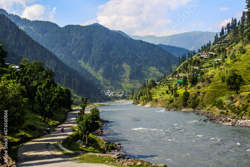 Picture of Mountain, Trees, River and Stream of adjoining areas of Kashmir. In this picture you can see the hill view along with stream and trees with beautiful scene of greenery on mountains photo