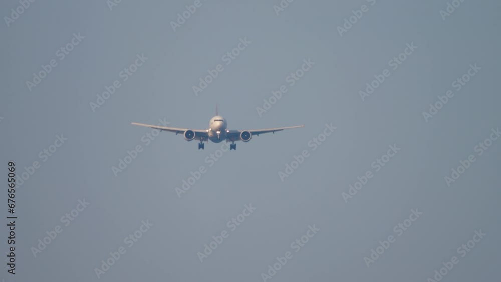 Commercial plane approaching landing at Phuket airport. airplane flying over the Mai Khao beach Commercial plane approaching landing at Phuket airport. airplane flying over the Mai Khao beach