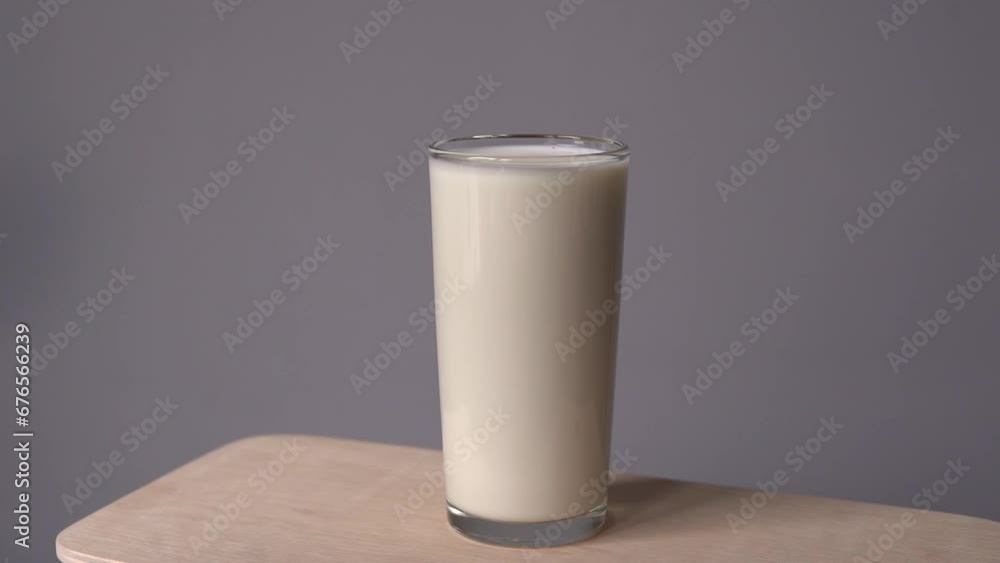 Pouring fresh milk into the glass. Pouring fresh milk into the glass.