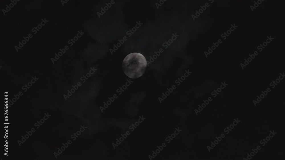 Clouds Floating Past a Bright Full Moon in the Dark Night Footage. Clouds Floating Past a Bright Full Moon in the Dark Night Footage.