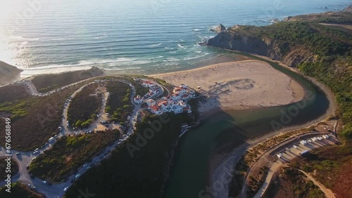 Aerial video filming by drone of the sea bay and beach near the village of Odeceixe Alentejo Portugal. Moving forward during sunset