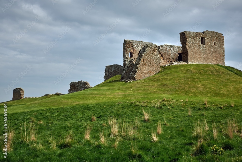 Duffus Castle on the Laich of Moray with a cloudy sky in the background, Scotland