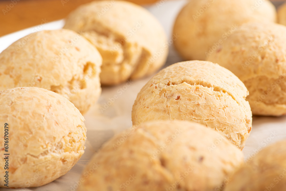 Cheese bread, shape with cheese bread arranged on rustic wood, dark background, selective focus. Cheese bread, shape with cheese bread arranged on rustic wood, dark background, selective focus.