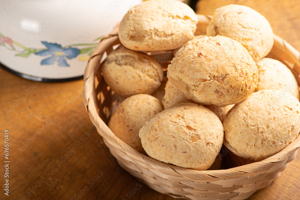 Cheese bread, basket with cheese bread arranged on rustic wood, dark background, selective focus. Cheese bread, basket with cheese bread arranged on rustic wood, dark background, selective focus.