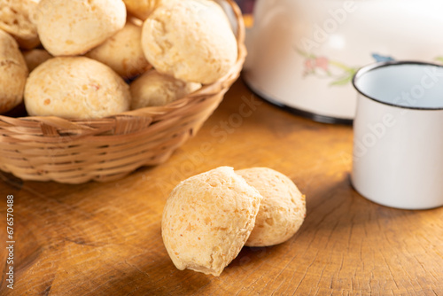 Cheese bread, basket with cheese bread arranged on rustic wood, dark background, selective focus.