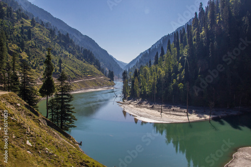 Picture of Mountain, Trees, River and Stream of adjoining areas of Kashmir. In this picture you can see the hill view along with stream and trees with beautiful scene of greenery on mountains