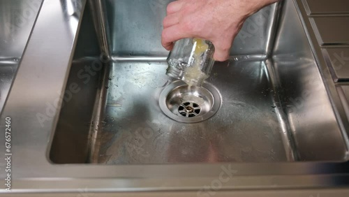 Old honey poured into kitchen waste, clogging the sink drain with honey