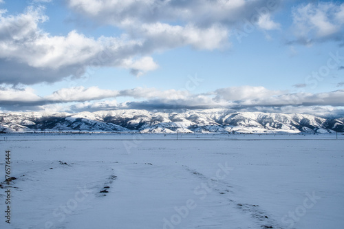 Snowy mountain range on a cloudy day © Wirestock