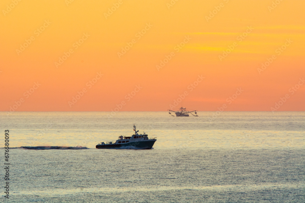 fishing boats at sunrise
