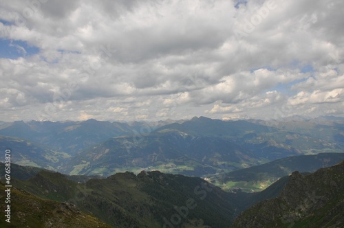 Beautiful landscape of big mountains of the Alps in Italy under the cloudy sky during the daytime