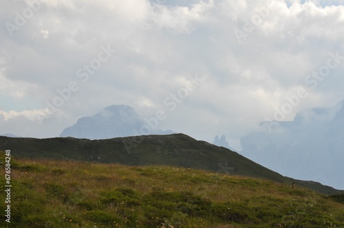 Beautiful landscape of big mountains of the Alps in Italy against the cloudy sky during the daytime