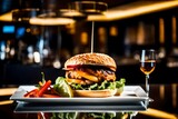 hamburger with fries, A delectable chicken burger rests on a glass table in a modern, high-end restaurant