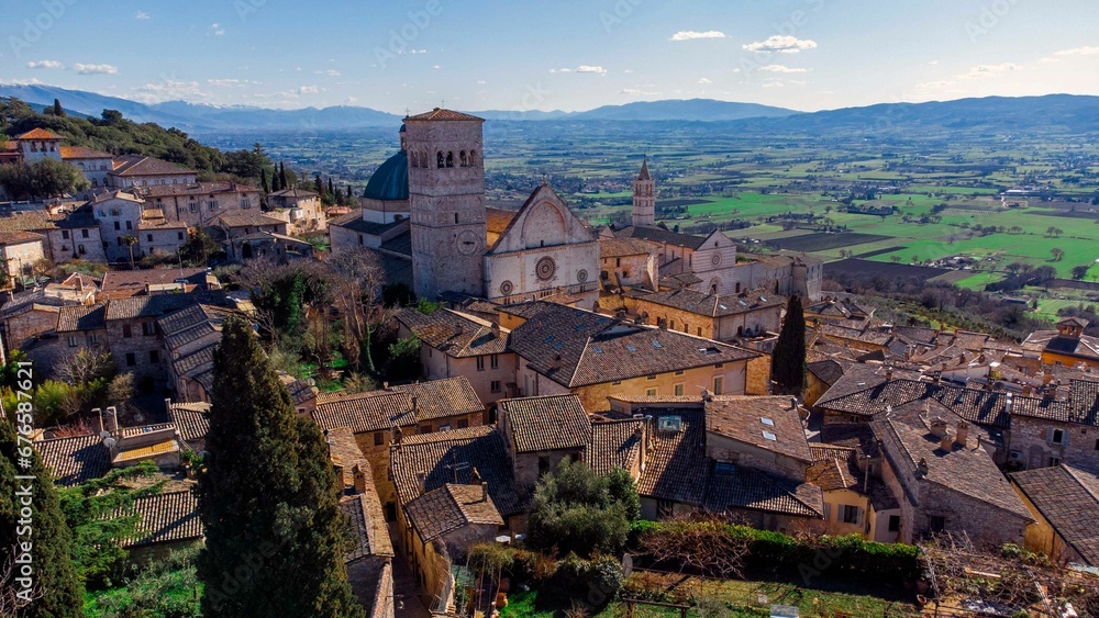 Drone shot of houses and the Church of San Francesco in Assisi, Italy