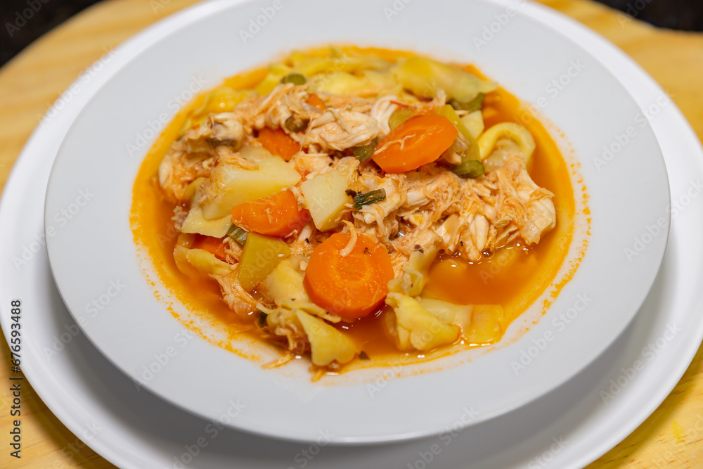 Traditional Italian tortellini (capeletti, agnolini) soup with chicken and vegetables, special soup for cold nights. Closeup